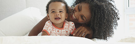 woman and her child smiling while laying down.jpg